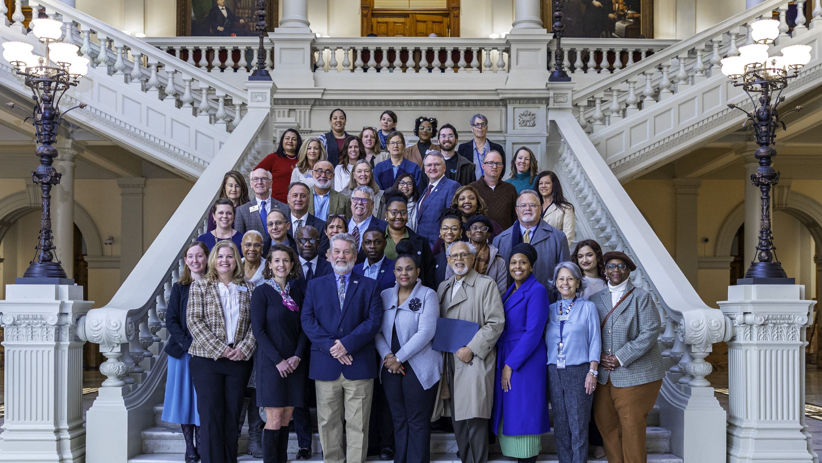 Photo of over 50 people posted on the capitol steps